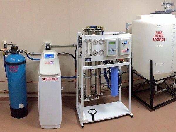 Water softener and purification system with storage tank in a utility room.