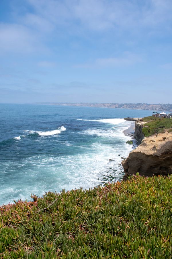 Rocky cliffs of La Jolla Cove overlooking beautiful blue waters.