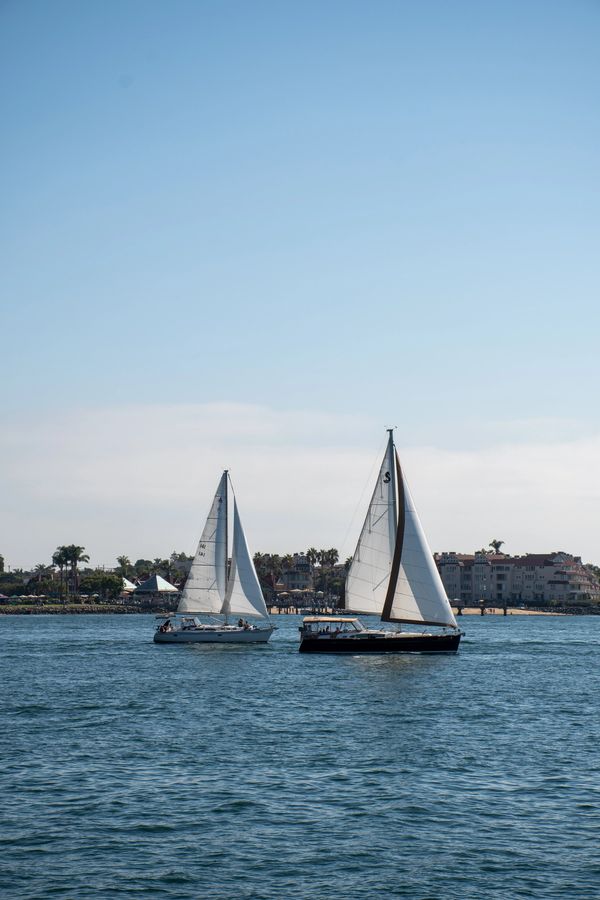 Two sailboats on the ocean between Coronado Island and San Diego.