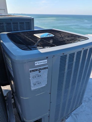 Outdoor Daikin inverter air conditioning unit near the ocean.