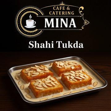 Tray of Shahi Tukda topped with almond slices in creamy sauce.