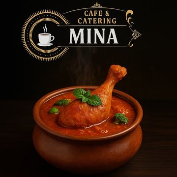 A steaming bowl of chicken curry garnished with fresh herbs at Mina Cafe & Catering.