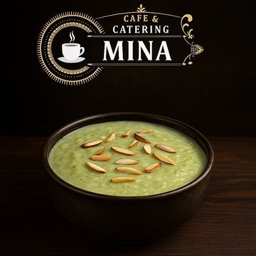 Creamy green soup garnished with almond slices in a dark bowl.
