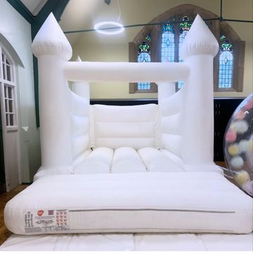 White inflatable bouncy castle indoors.