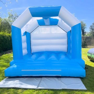 Blue and white inflatable bounce house set up outdoors.