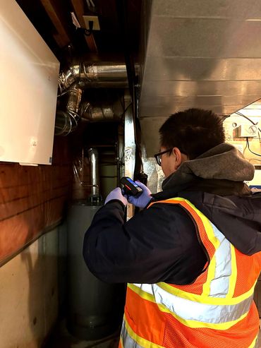 Conducting a background radiation check in a residential basement.