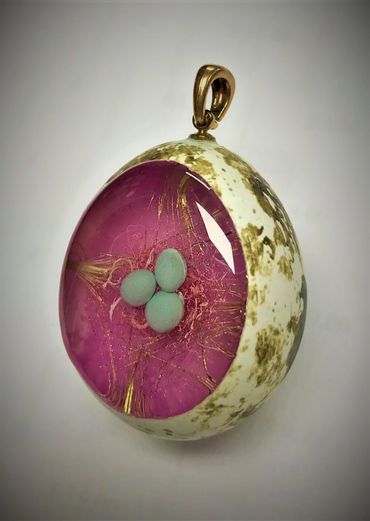 A real quail egg with eggs in a nest pendant. Hand made in the USA.