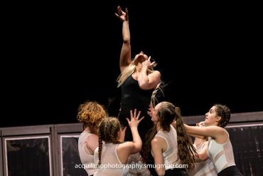 Sing-Out dancers perform on stage.