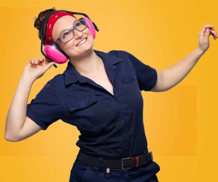 Louise wearing pink ear muffs, a navy shirt and a red bandana