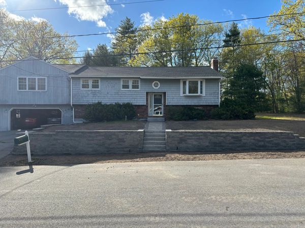 Suburban split-level house with garage and mailbox.