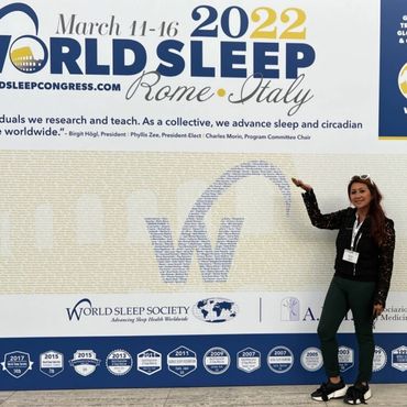Woman pointing at sleep poster.