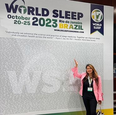 Woman in front of backdrop.