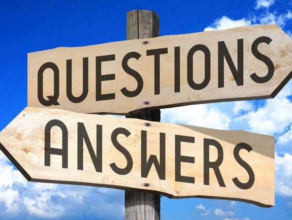Wooden signpost with questions and answers directions.