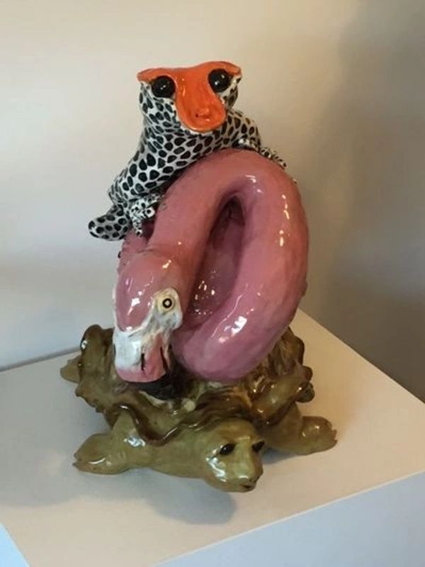 a frog riding a flamingo riding a tortise