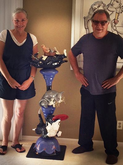 Renate and Gordon with their commissioned totem, "The Catch" featuring their pets.