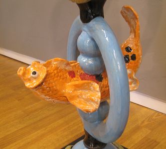 Blue ring with an orange koi fish swimming through.