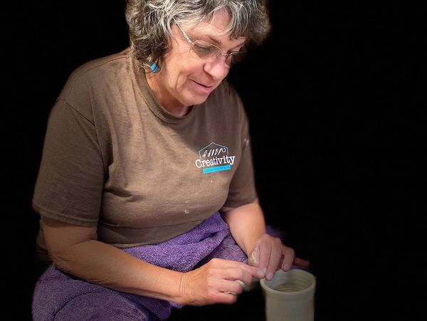 Teacher and pottery wheel