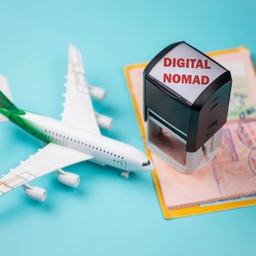 Stamp with 'Digital Nomad' near airplane model and passport.