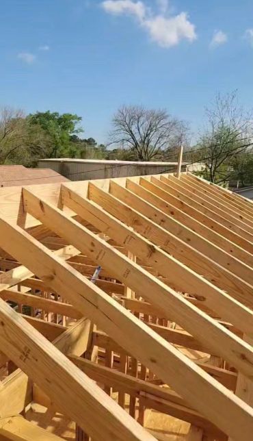 Wooden roof framework under construction.