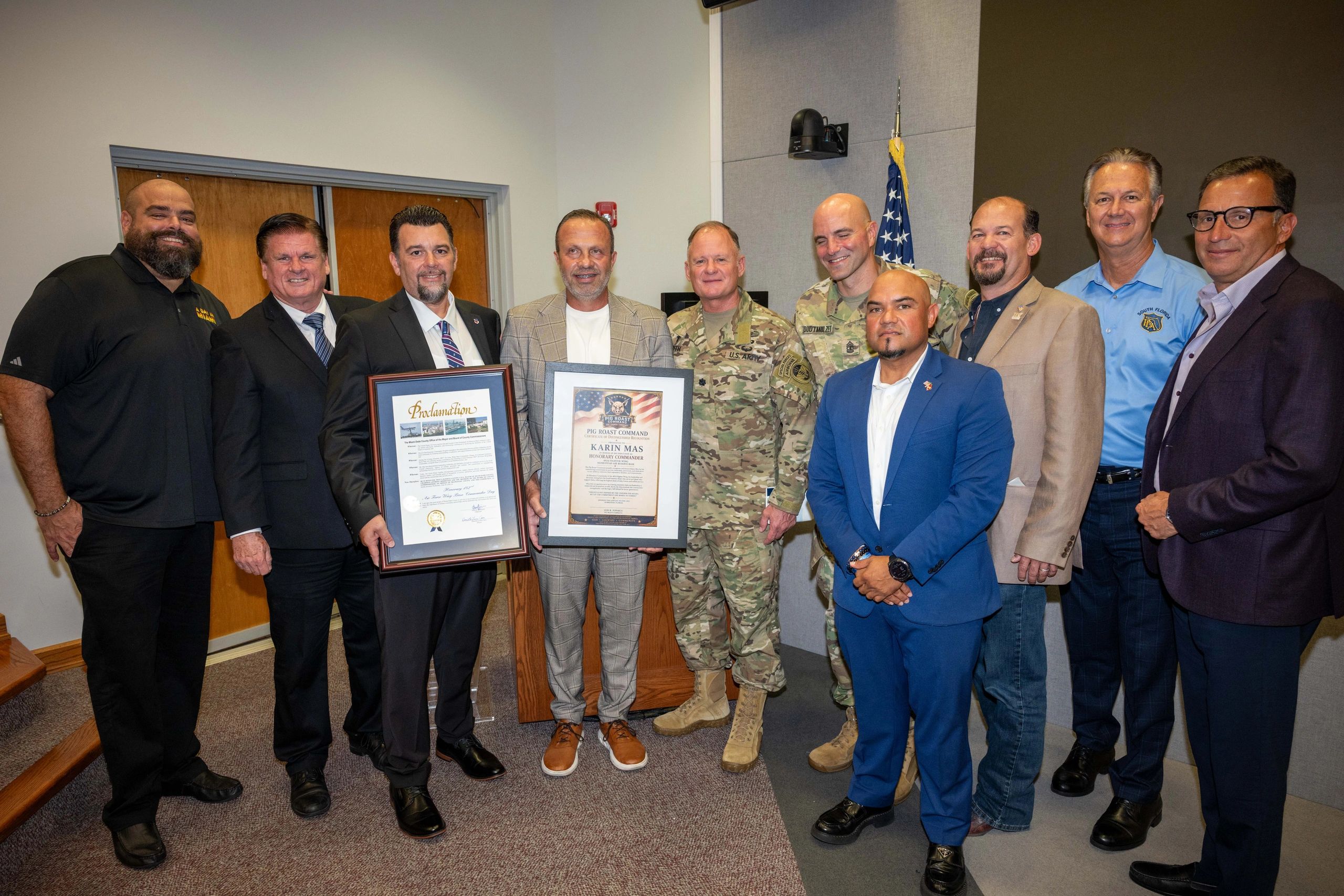 Group photo of men holding framed proclamations, some in military uniforms.