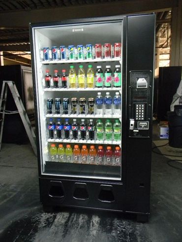 A vending machine stocked with various soda and energy drinks.