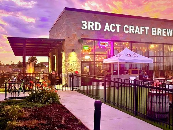 3rd Act Craft Brewery with outdoor seating at sunset.