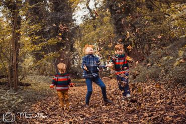Autumn portrait. Kids playing with leaves