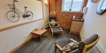The Humber Room, Humber Therapy Centre. Two bentwood armchairs, a sink, windows and soft lighting.