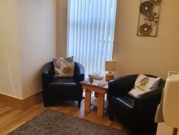 The Daisy Room, Magnolia Therapy Centre. Two tub chairs, windows and soft lighting.