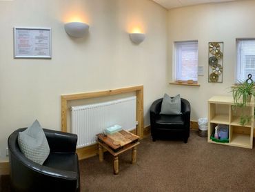 The Lily Room, Magnolia Therapy Centre. Two tub chairs, windows and soft lighting.