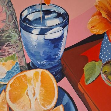 STILL LIFE image of a glass of water in a blue glass with a plate of cut oranges & a crust of pizza