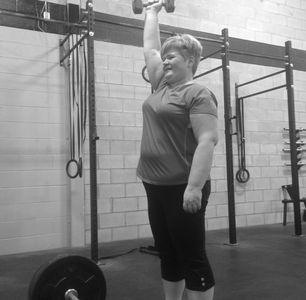 A client doing an overhead press during a Personal Training session. 