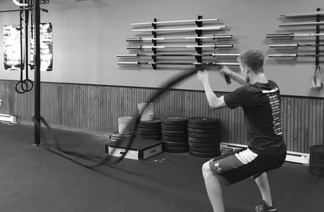 An athlete using battle ropes during a Personal Training Session.