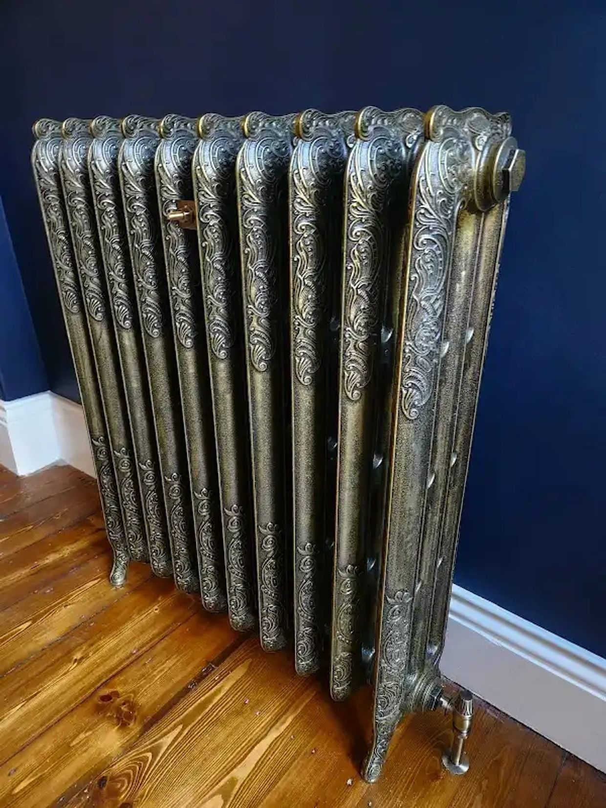 Ornate vintage cast iron radiator with intricate floral designs.