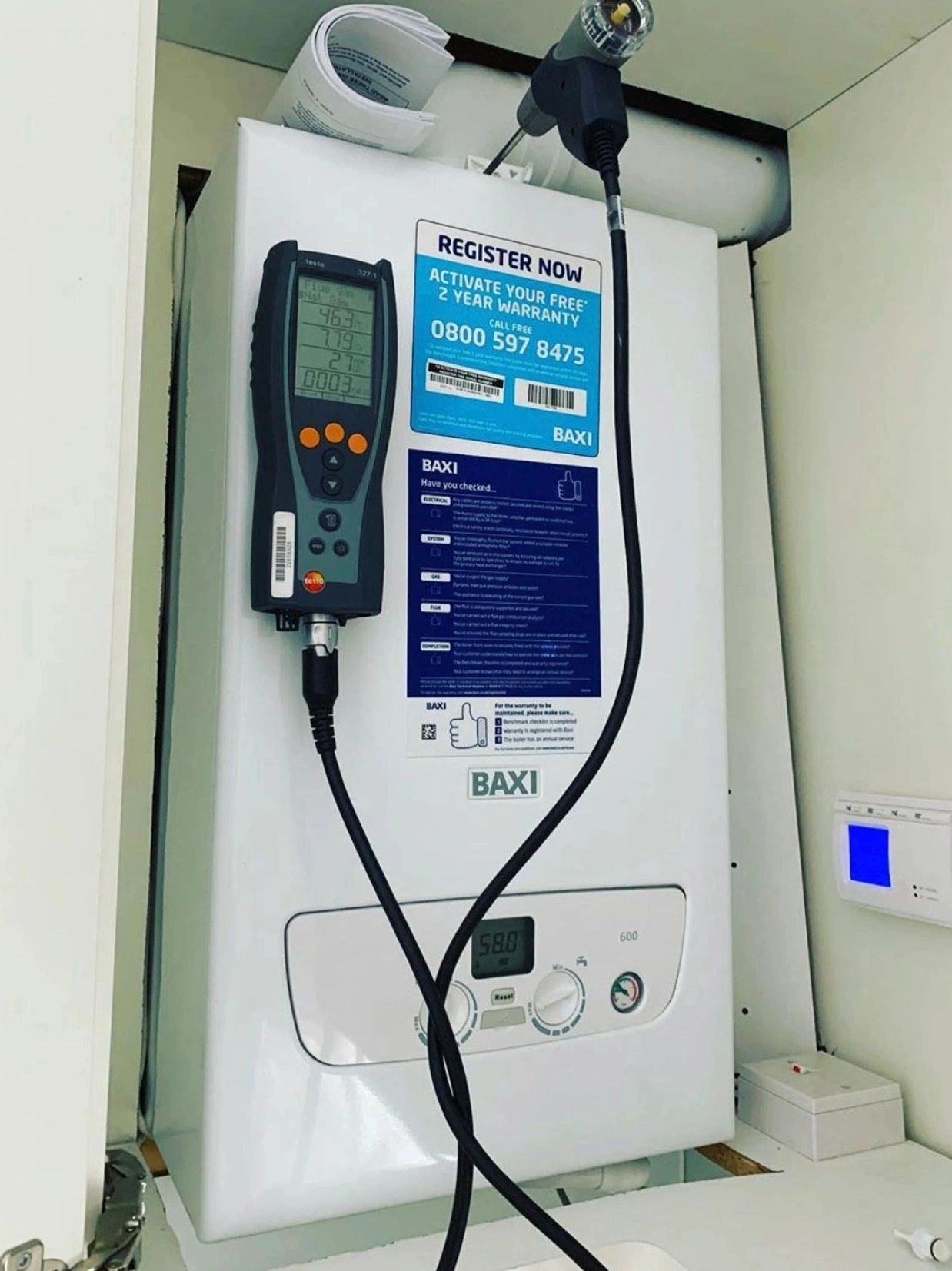 A Baxi boiler with attached diagnostic tool and control panel.