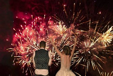 Couple celebrating fireworks on their wedding day.