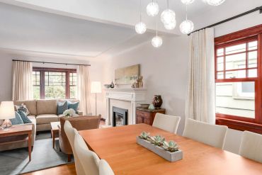 Bright and cozy living and dining area with modern furniture and soft lighting.