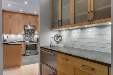 Modern kitchen with wooden cabinets and stainless steel appliances.