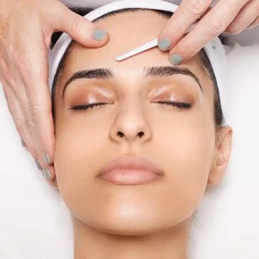 Girl receiving a dermaplane treatment