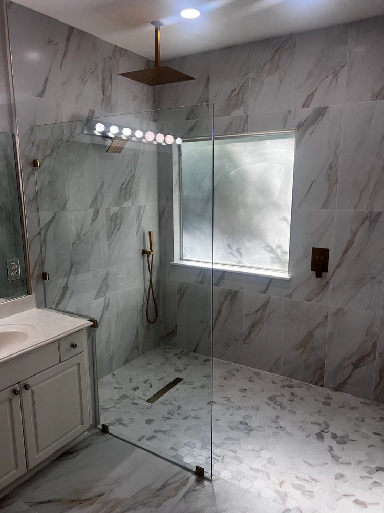 Stack of books next to pencils in a holder and a camera.