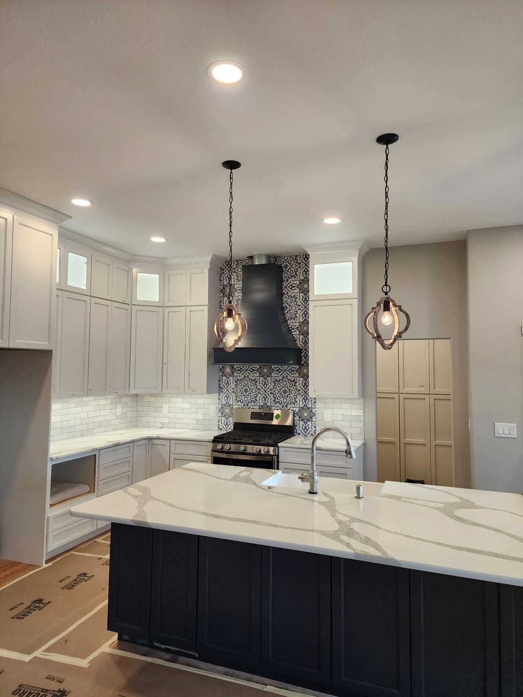 Kitchen remodel with new recessed lighting, pendant lighting, and undercabinet lighting.