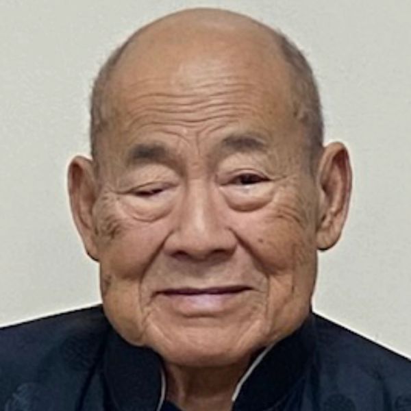 Portrait of an elderly man with a gentle smile.