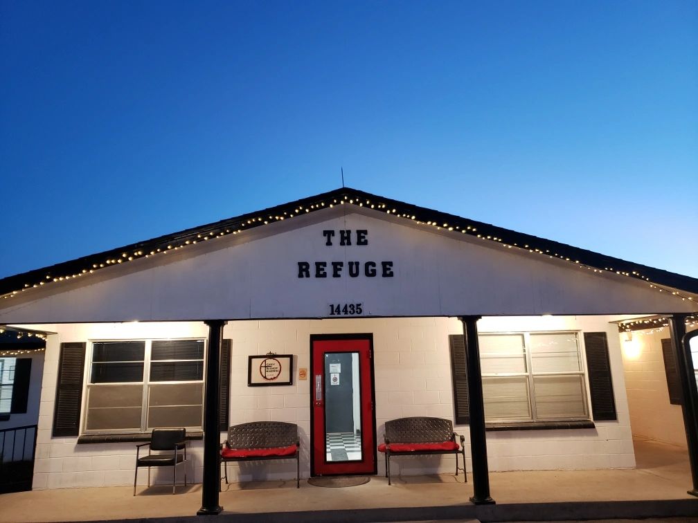 The Refuge building entrance at dusk.