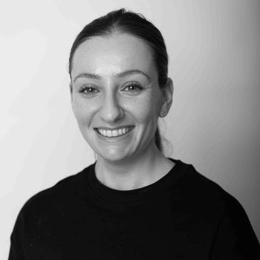 Black and white portrait of a smiling woman.