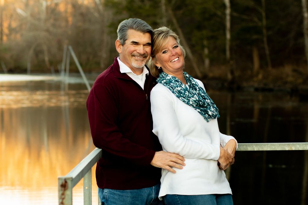 couple by the river on a dock at Cozy Cove in Branson, MO with golden hour light