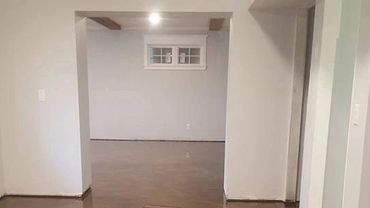 Room with glossy, marbled brown epoxy floor and white walls.