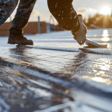 Person applying waterproof coating on a roof.