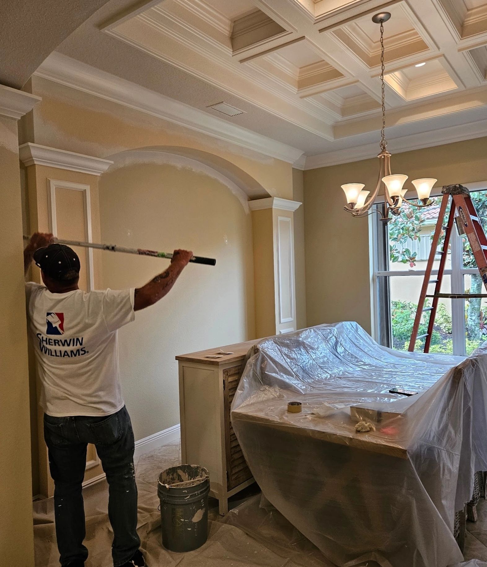 Simone Painting crew member painting interior trim in a home