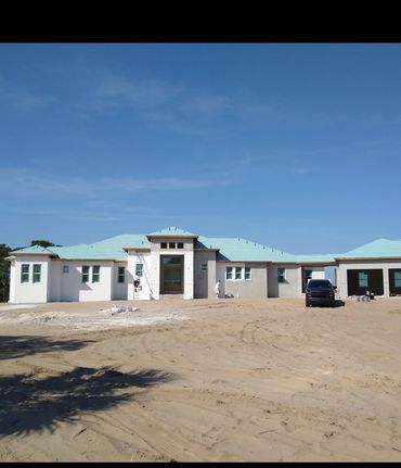 Completed exterior paint job on a Port Charlotte home with metal roof