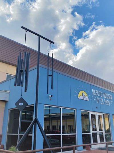 handcrafted wind chimes hanging in front of the Rescue Mission of El Paso